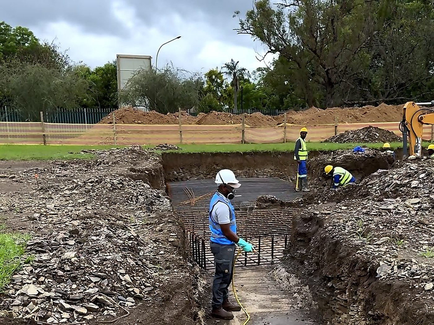 Foundation trenches open and reinforcing in place, treated ahead of the slab pour.