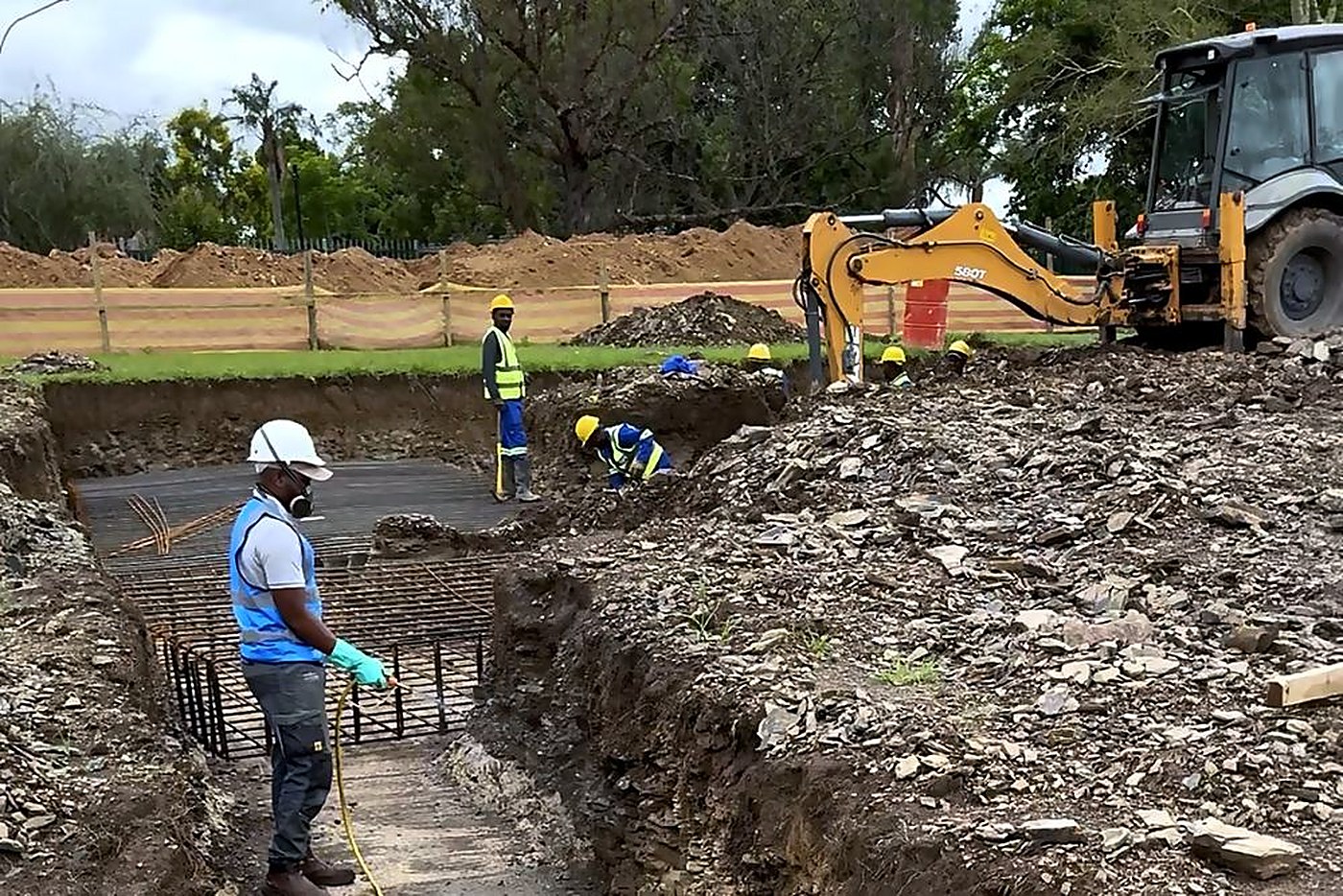 A real job mid treatment, trench open and product going down before the pour.