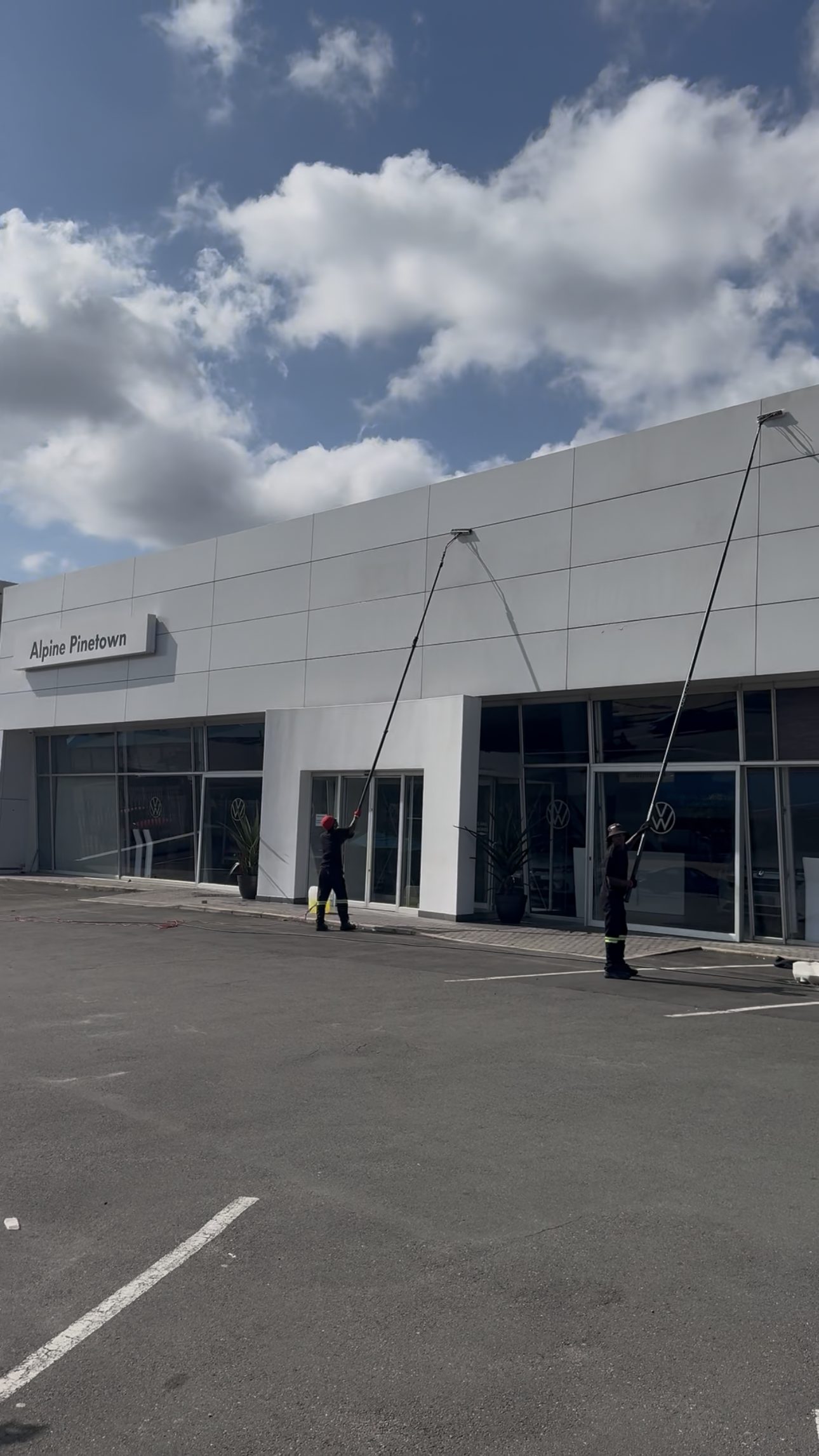 Two operators on a shopfront, no ladders, no harnesses, no scaffold.